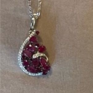 White gold necklace and pierced earrings with diamonds and rubies. 18in chain.